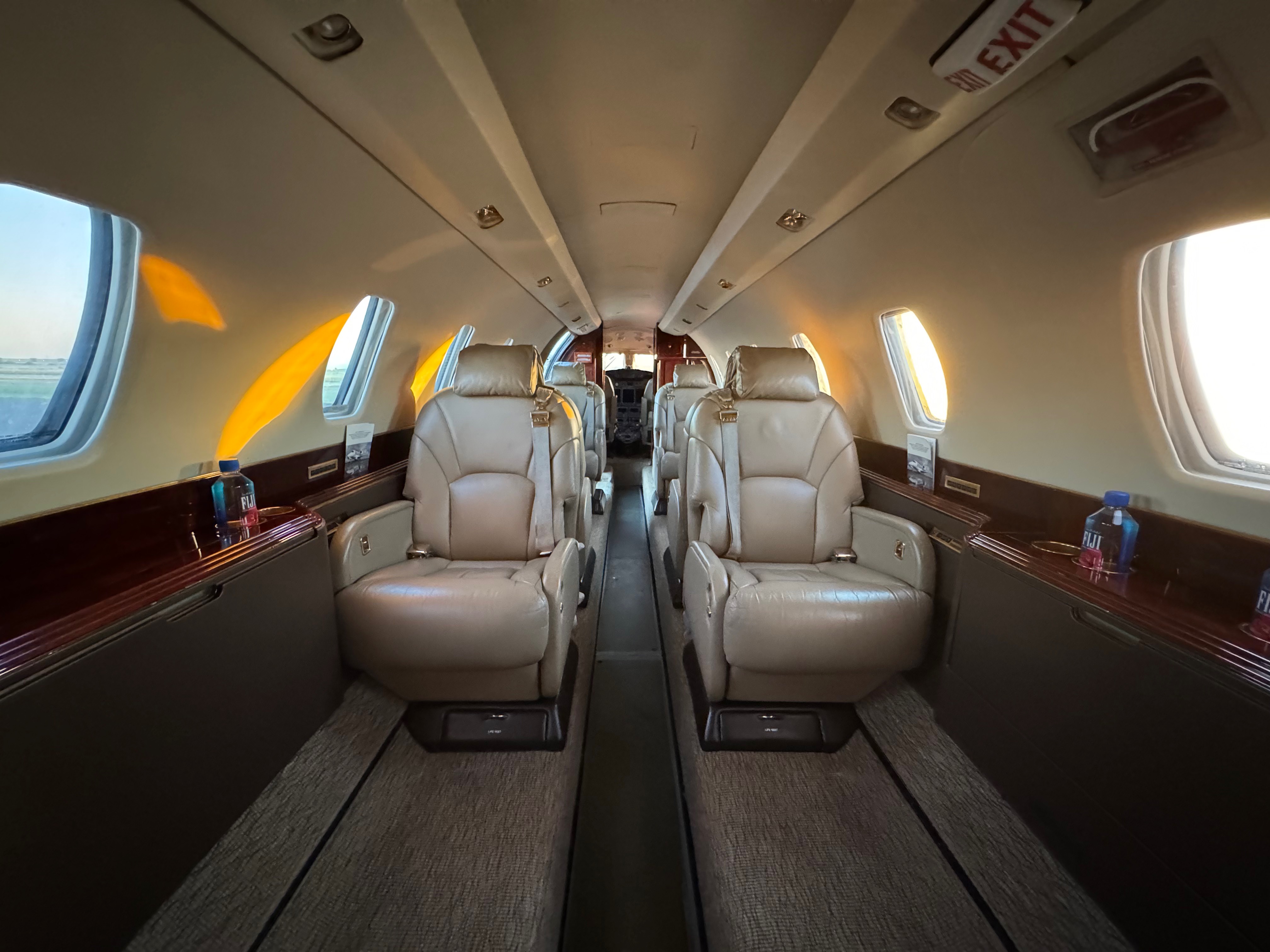 San Jose Aircraft Interior Detailing — private jet cabin with tan leather club seating and wood trim