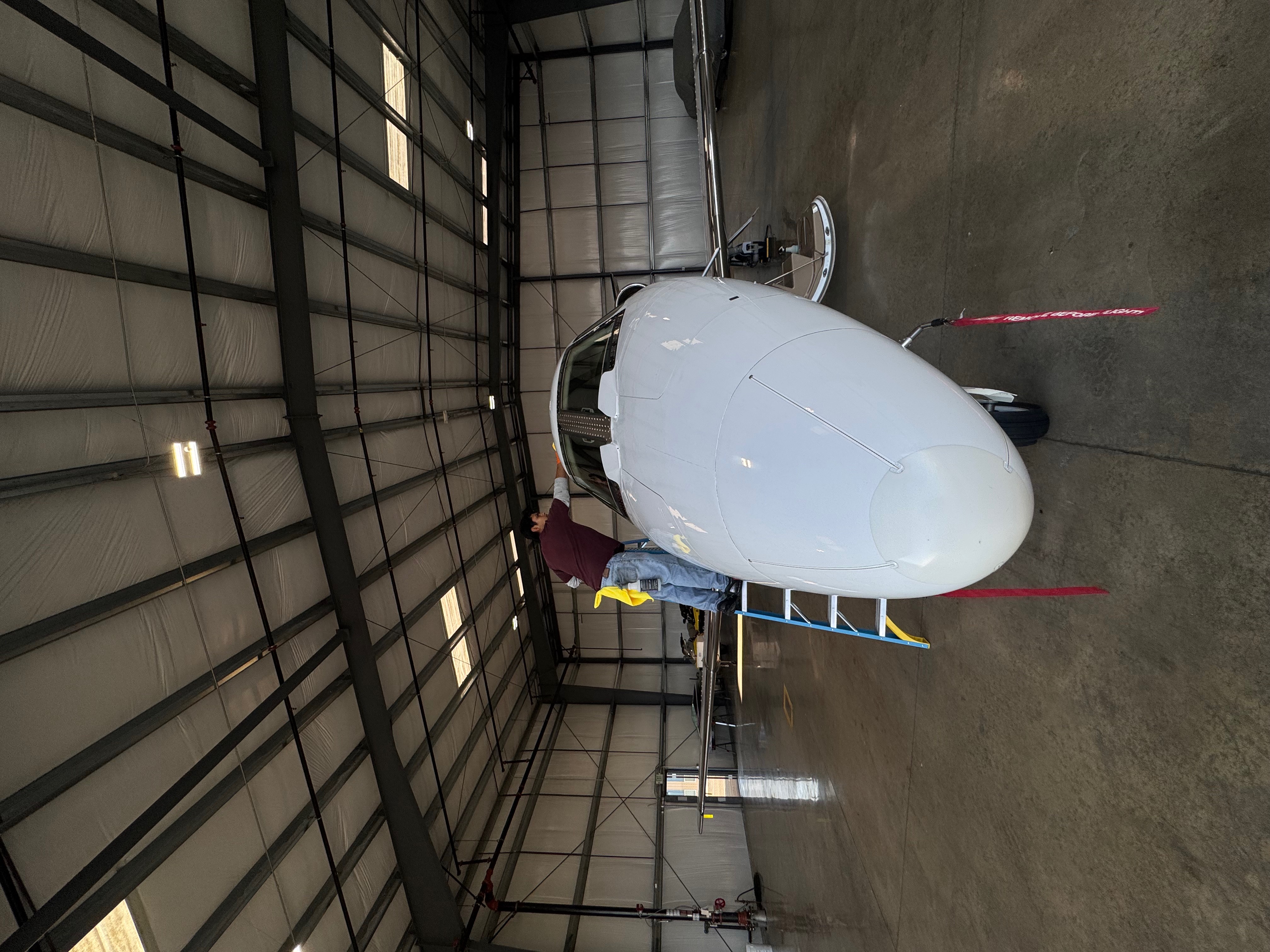 Aircraft detailing work in hangar at San Jose International Airport KSJC