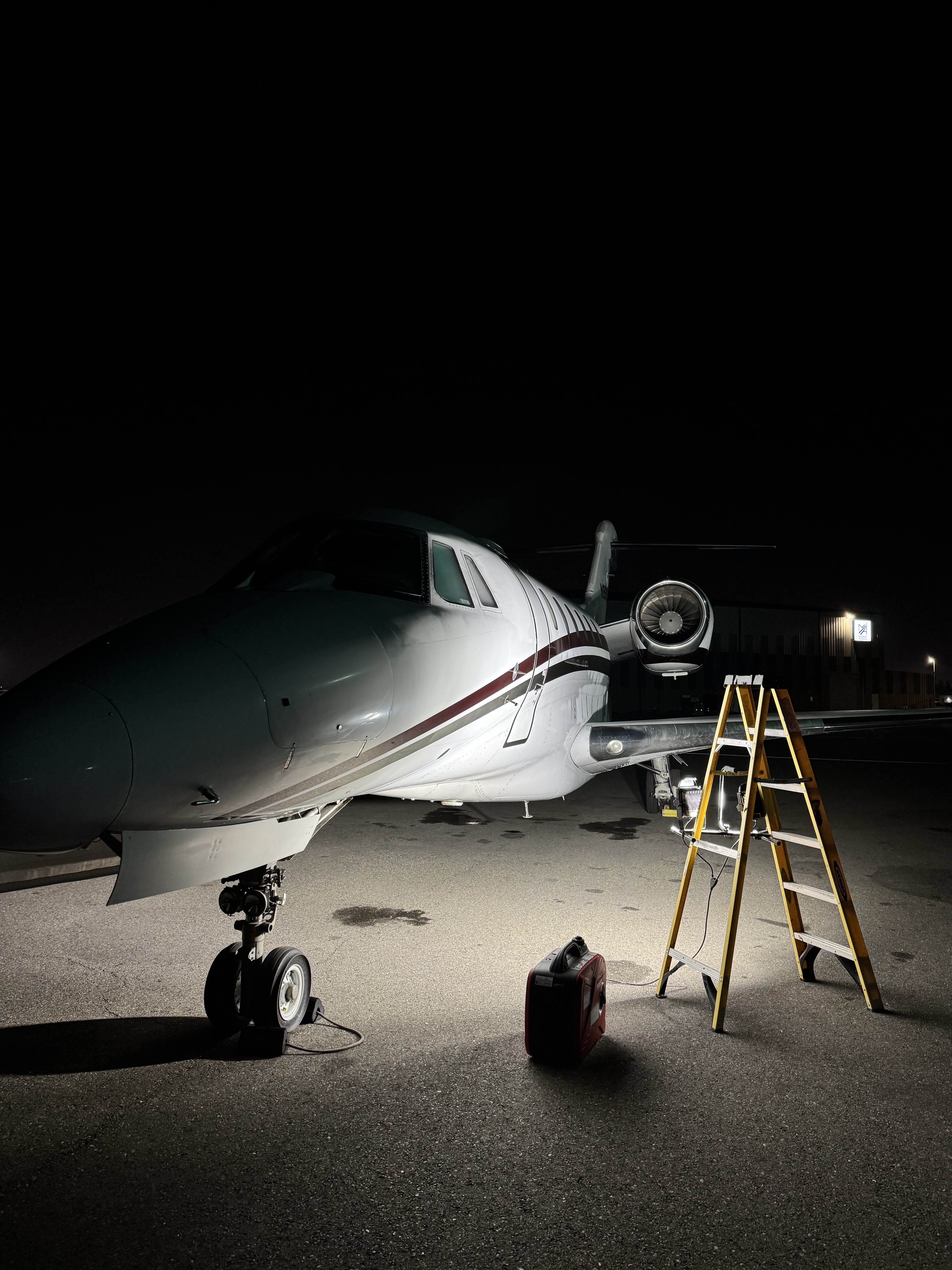 Aircraft Belly Degreasing Bay Area — underside and gear area detailed at night on the ramp