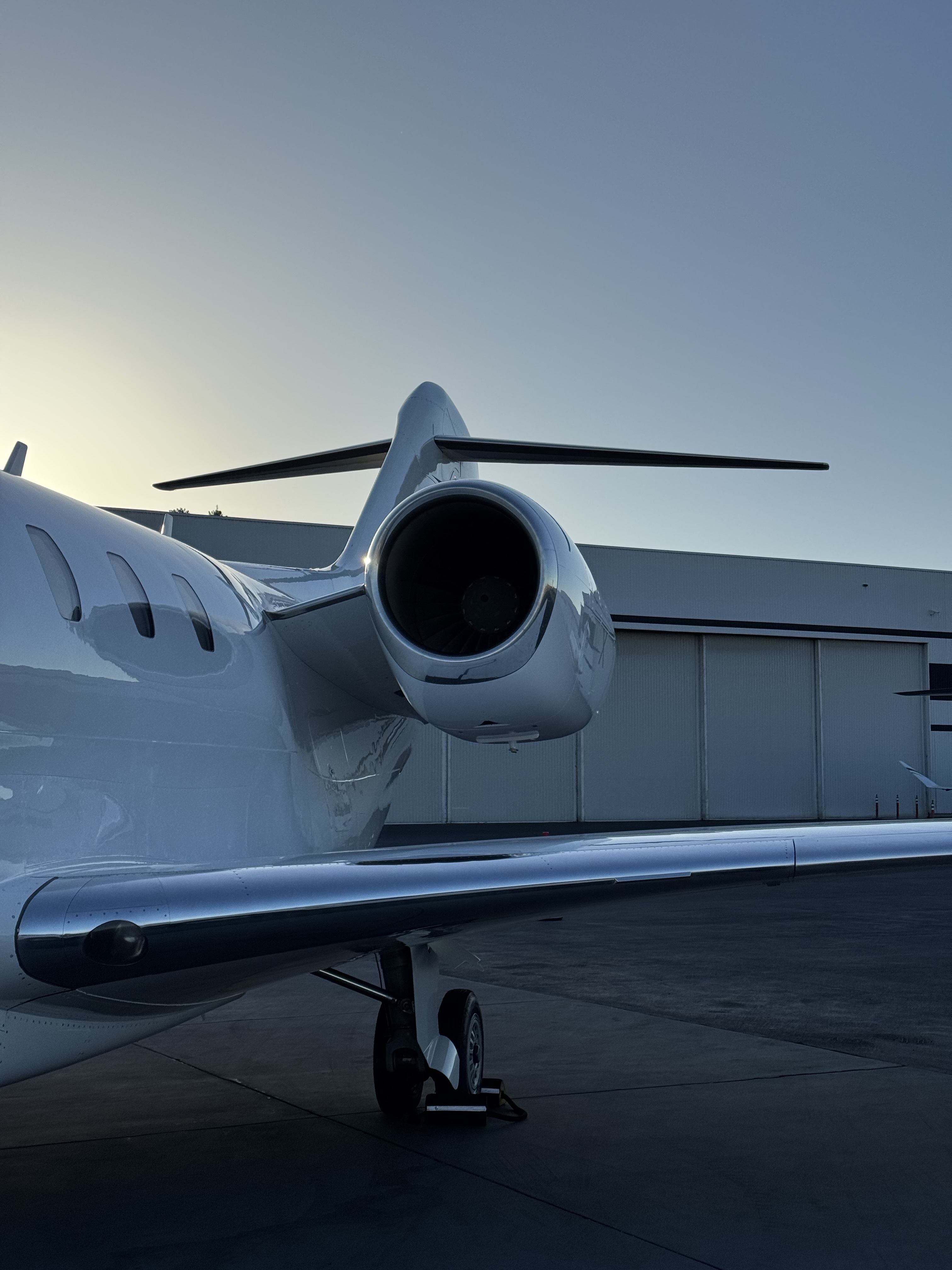 Aircraft De-Icing Detail Bay Area — aircraft serviced on the ramp under work lights at dusk